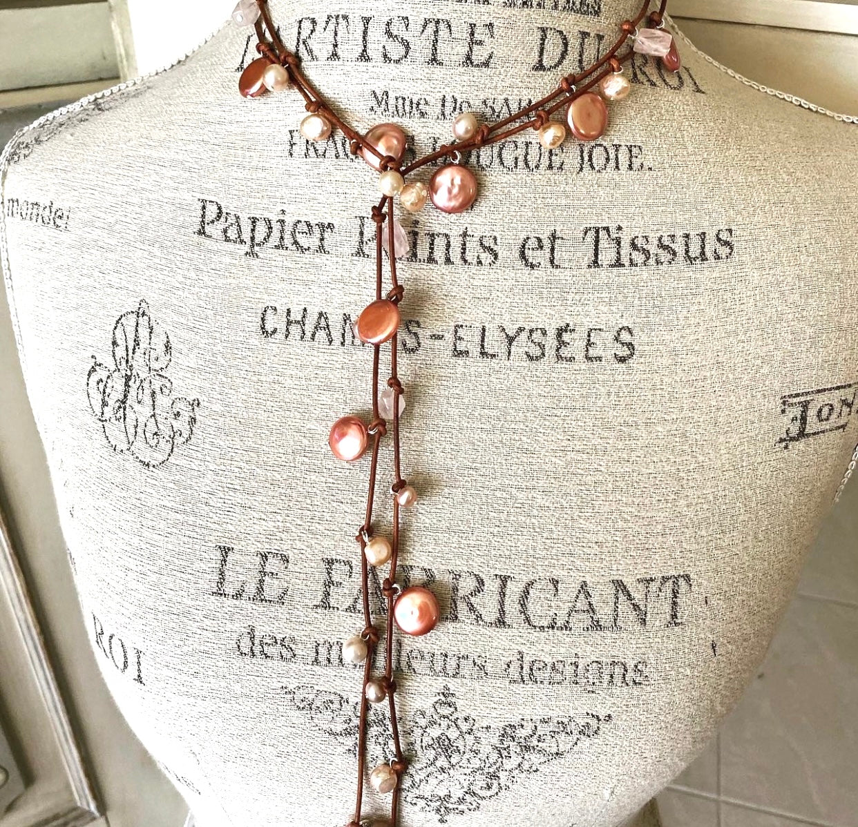 Stasha Soulstring of coin pearls and rose quartz on light brown lariat necklace